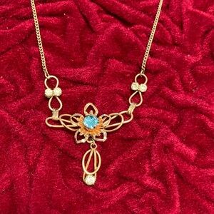 Elegant Gold Necklace with Blue Gem